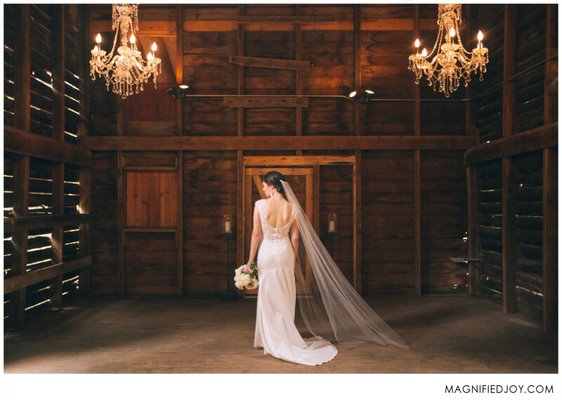 Bride in the rustic, elegant barn ceremony location at Camrose Hill